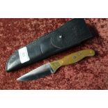 Sheffield made sheath knife with 3 1/4 inch blade and two piece grips, complete with leather sheath