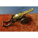 Brass fire side cannon with 11 1/2 inch staged barrel and cast metal carriage