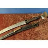Unusual extremely large African type sword with 27 inch slightly curved engraved blade, inlaid