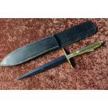 Unusual Commando style dagger with 6 1/2 inch blackened stiletto blade, the brass crosspiece