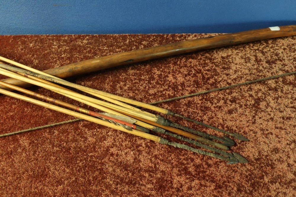 Tribal style bow and a selection of various assorted arrows