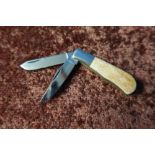 Small twin bladed pocket knife with two piece horn grips