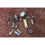 A watch mainspring winder, sleeve spider, miniature vice, hand puller and other items including an