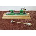 Small engineering type lathe mounted on oak plinth and a small hammer (2)