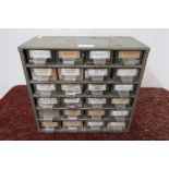 Metal engineering drawer of 24 drawers containing main springs, balances, escape wheels and other