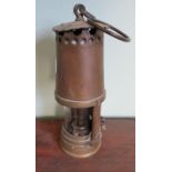 Vintage brass miners lamp with rear shade and locking plate