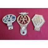 Three car radiator badges including AA, 986239 and V197502 and an oval RAC badge PA1334 (3)