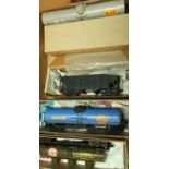 Six boxed and one unboxed American style O gauge rolling stock including open wagons, tankers,