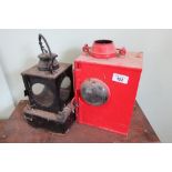 Railway lamp interior and a red painted lamp with bullseye glass internal burner and makers plaque