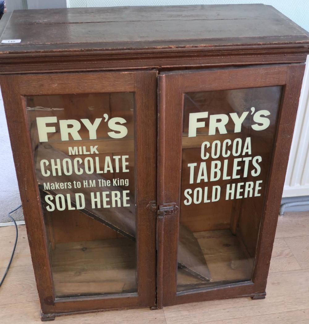 Early 20th C cabinet enclosed by two glazed cupboard doors with painted stenciled detail for Fry's