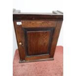 Early 19th C oak wall spice cupboard enclosed by single panelled cupboard door revealing open