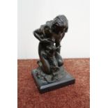 Signed bronze figure of a kneeling nude lady and lamb feeding from her breast, mounted on square