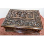 Elaborately carved rectangular oak table box with hinged lift up lid and light oak fitted