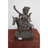 A large bronze figure of a mounted female shaman/witch on horseback with various pendants, hanging