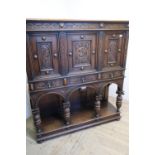 Quality carved oak court style cupboard with three upper carved and panelled doors above three