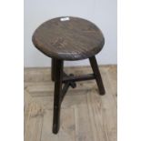 Interesting 19th C primitive three legged elm stool with circular top and interconnecting cross