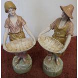 Pair of Royal Dux figures in the form of a lady and gentleman carrying baskets, with shamrock detail