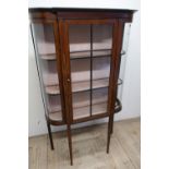 Edwardian mahogany inlaid three tier display cabinet enclosed by a single glazed cupboard door on