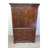 18th C burr walnut chest on chest with stepped cornice above two panelled cupboard doors with