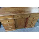 Victorian pitch pine serving table with three frieze drawers above central panelled cupboard door
