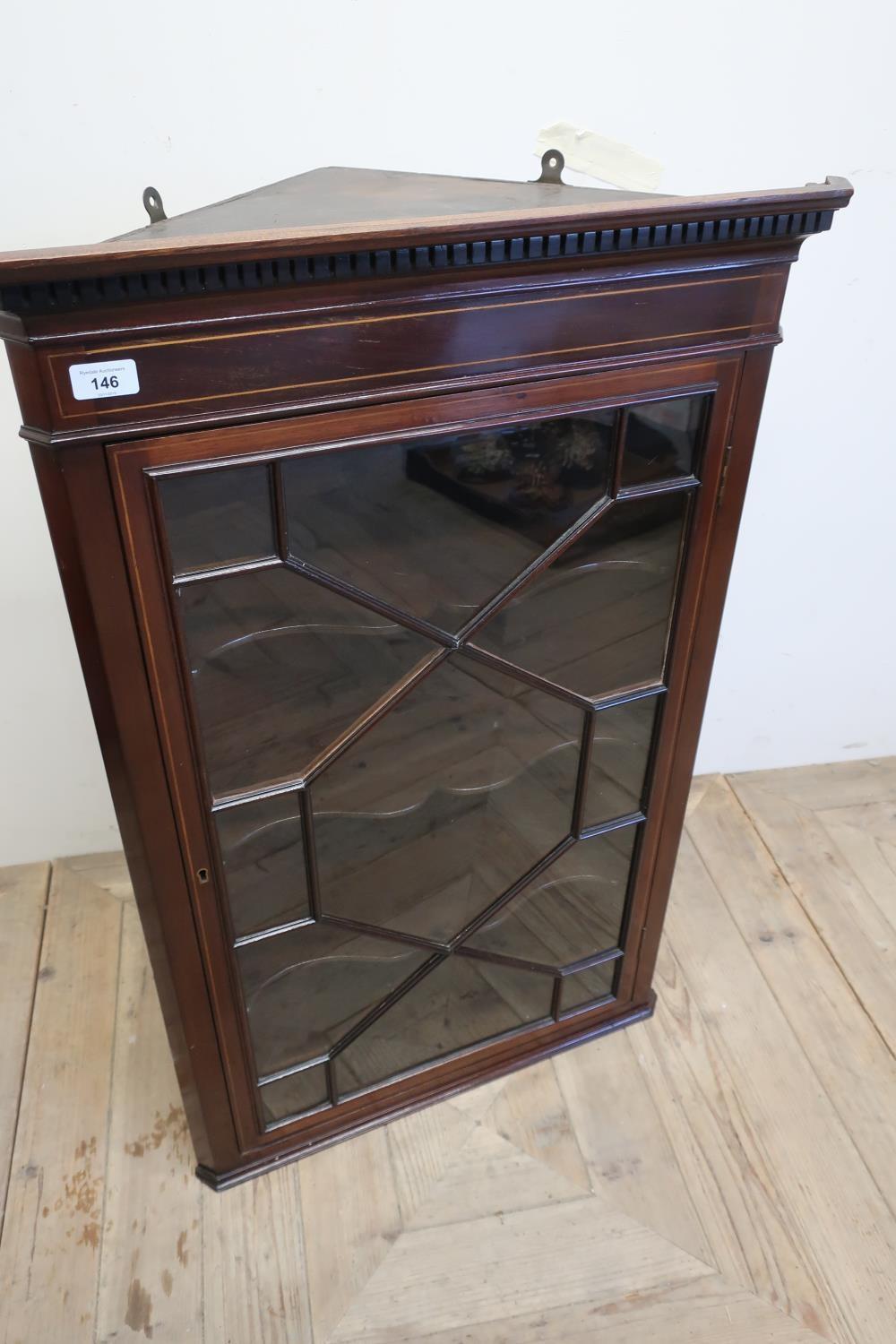 Edwardian mahogany inlaid corner cupboard enclosed by single glazed door, with three shelves to