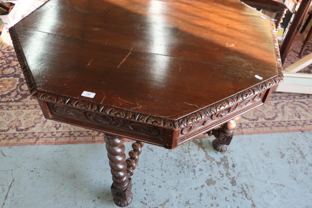 Oak octagonal dining table with carved detail, X shaped stretcher and barley twist supports (