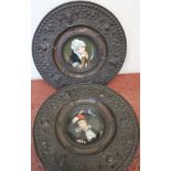 Pair of shallow porcelain dishes painted with head & shoulder portrait of young ladies, mounted in