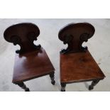 Pair of early 19th C mahogany chairs with solid backs and seats, on turned supports