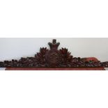 Carved wood Victorian pediment with Victorian crowned badge within laurels of oak leaves (length