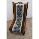 Late Victorian mahogany framed easy chair on turned supports with upholstered seat and back with