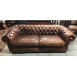 Large Victorian style brown two seat Chesterfield leather sofa with two large cushions and deep