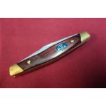 Buck USA three bladed pocket knife with wooden and brass grips