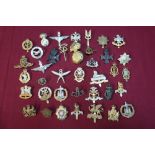 Box containing a large selection (approx 50) various military cap badges including staybright