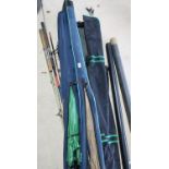 Collection of seven fishing rods of various makers, rod bags, umbrella and two tubes