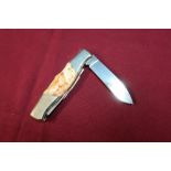 Twin bladed pocket knife with two piece horn grips