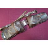 Tan leather double saddle holster with stamp marks 88 and various leather straps