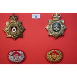Board mounted with staybright Kings Division Regiment helmet badges and two embroidered bugle badges