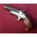Colt .41 cal Derringer type pistol with 2 1/2 inch swivel type barrel and two piece wooden grip etc