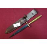 Unusual Commando style knife with 7 inch double edge blackened blade, brass crosspiece and shell