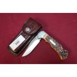 Rigid USA RG73 pocket knife with 3 inch folding blade, two piece grip and tooled leather belt pouch