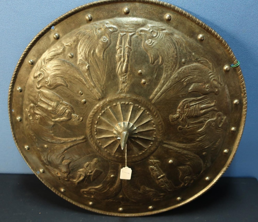 A large metal classical style circular shield (diameter 23 inches), with embossed scenes of dolphins