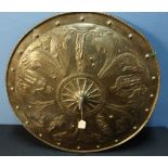 A large metal classical style circular shield (diameter 23 inches), with embossed scenes of dolphins