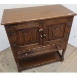 Old Charm style side cabinet with two paneled cupboard doors with linenfold detail, above single