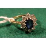 18ct gold diamond and sapphire flower head ring with large oval faceted sapphire surrounded by ten