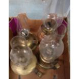 Early 20th C 'Go to Bed' oil lamp with glass reservoir and three brass bodied 'Go to Bed' oil lamps