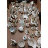 Approximately fifty pieces of souvenir crested china, including one of a tank, contained in one box