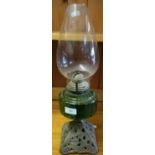 Early 20th C oil lamp with green glass reservoir and cast metal base