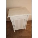 Painted side cabinet enclosed by single cupboard door with barley twist supports