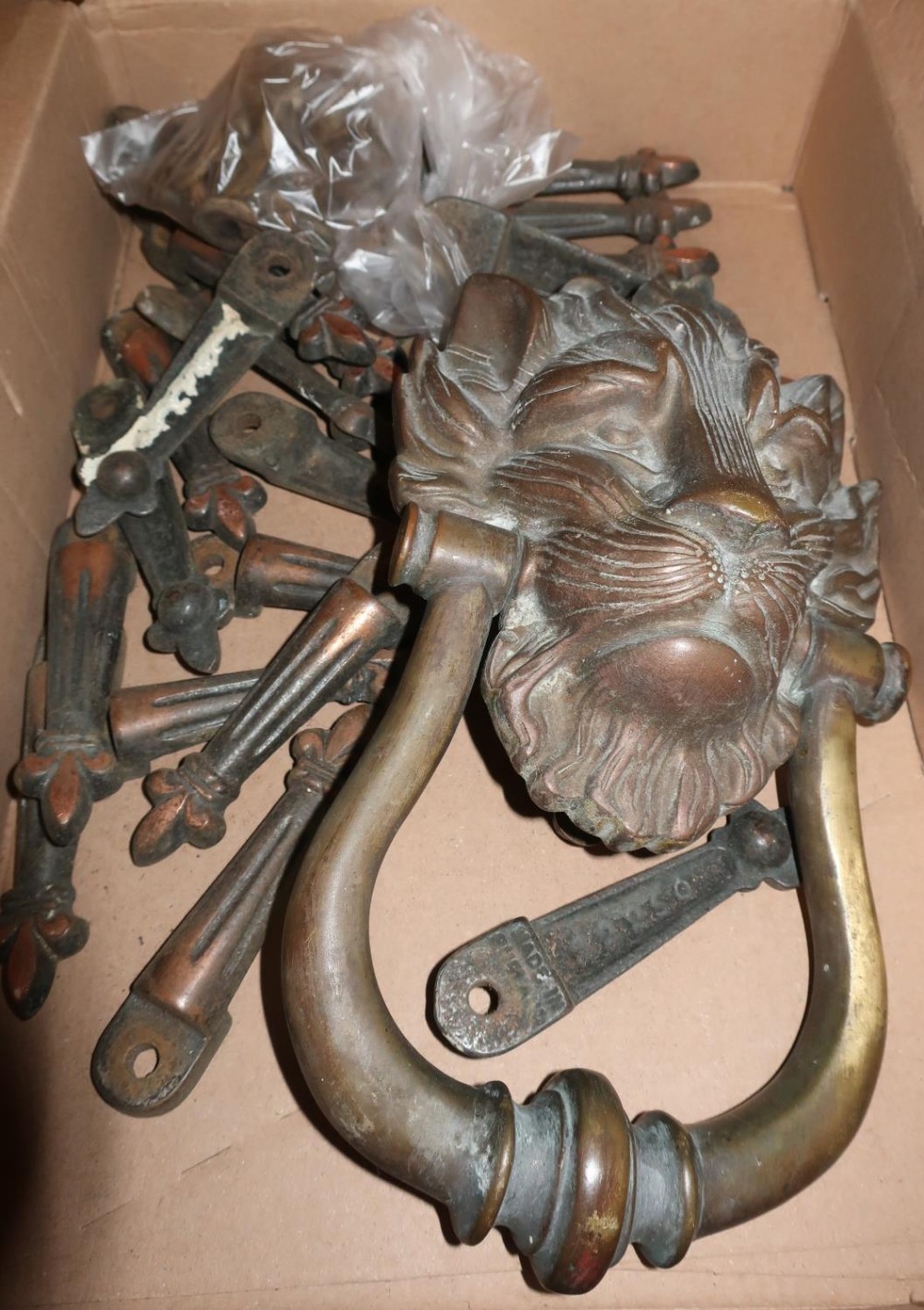 Heavy bronze lion mask doorknocker and a selection of brass carpet runner fixings No. 22250