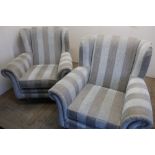 Pair of modern upholstered wing back armchairs on square tapering supports and brass casters